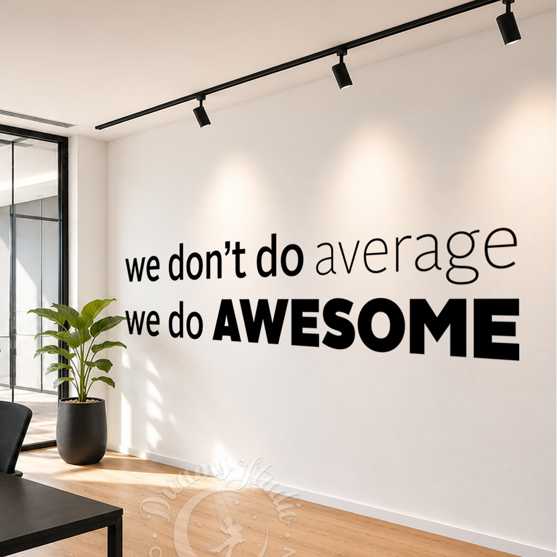 Modern office interior with motivational wall quote 'we don't do average, we do AWESOME' on a white wall.