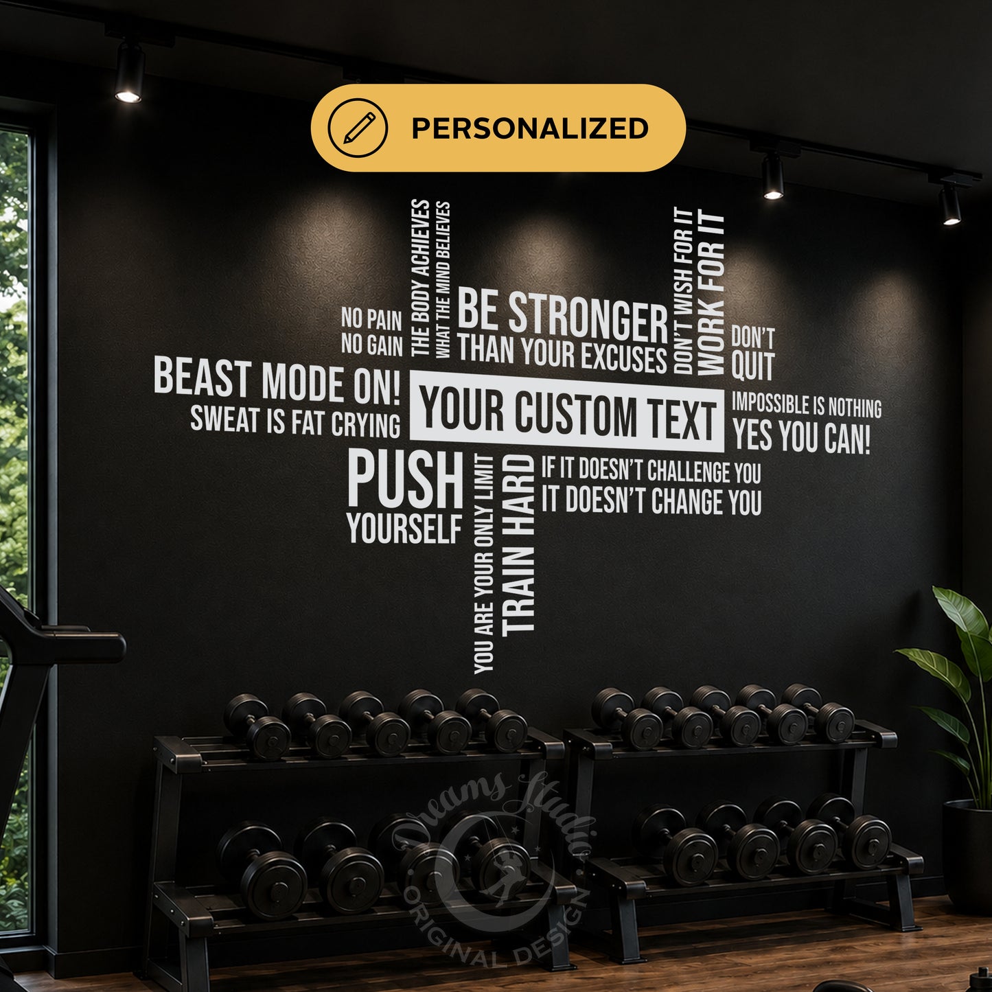 Personalized gym wall decal in white text on a black wall, featuring motivational fitness quotes and a custom center text area above dumbbell racks.