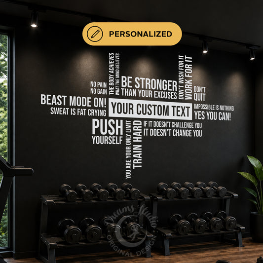 Personalized gym wall decal in white text on a black wall, featuring motivational fitness quotes and a custom center text area above dumbbell racks.