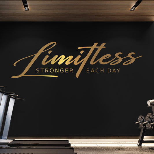 Gym interior with 'Limitless Stronger Each Day' motivational quote on a black wall.