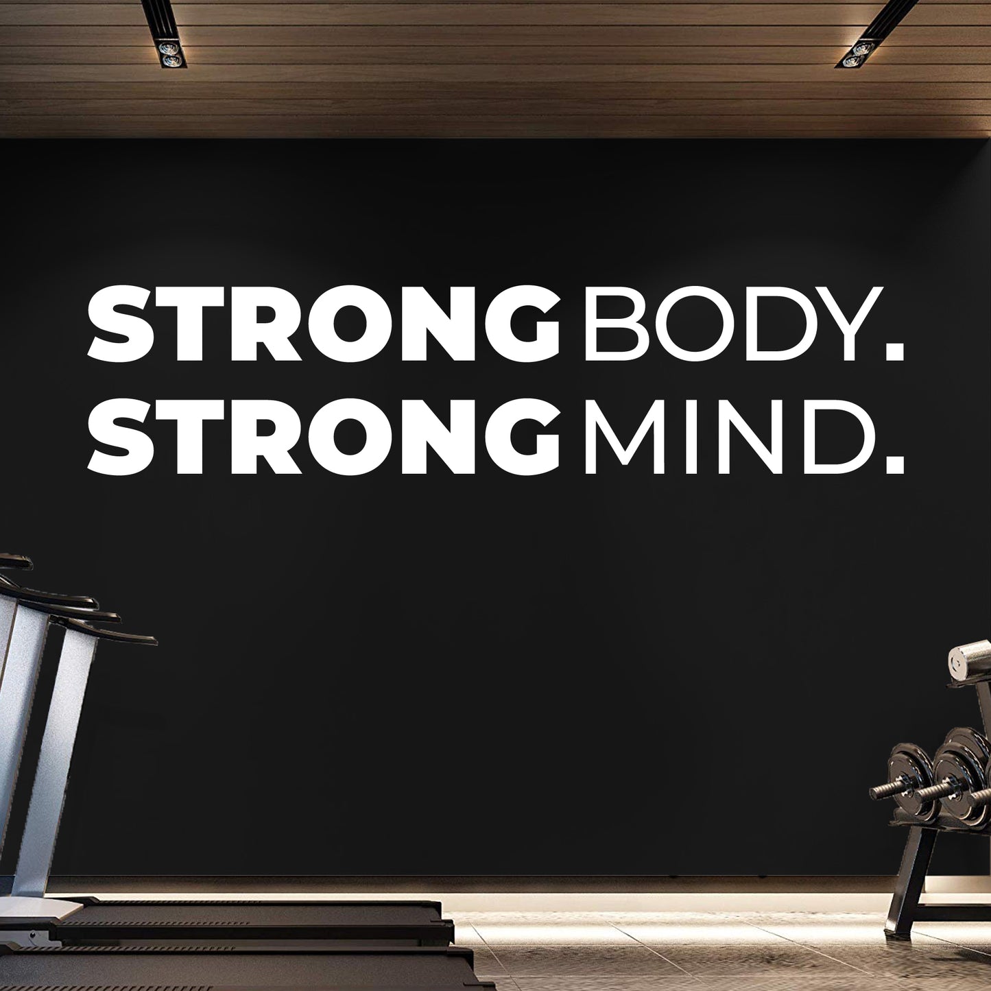 Gym interior with 'Strong Body. Strong Mind.' motivational quote on a black wall.