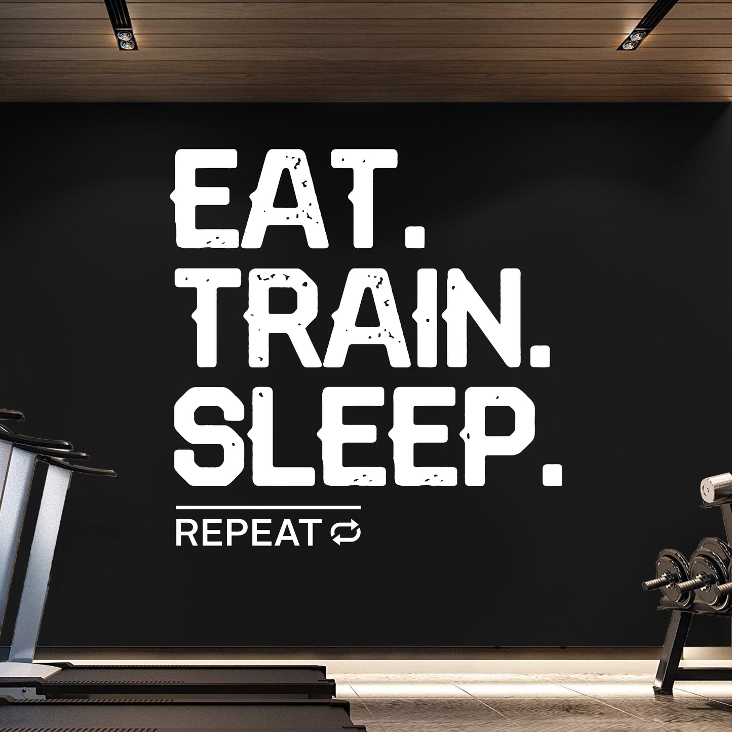 Motivational quote 'EAT. TRAIN. SLEEP. REPEAT' on a black wall in a gym setting.