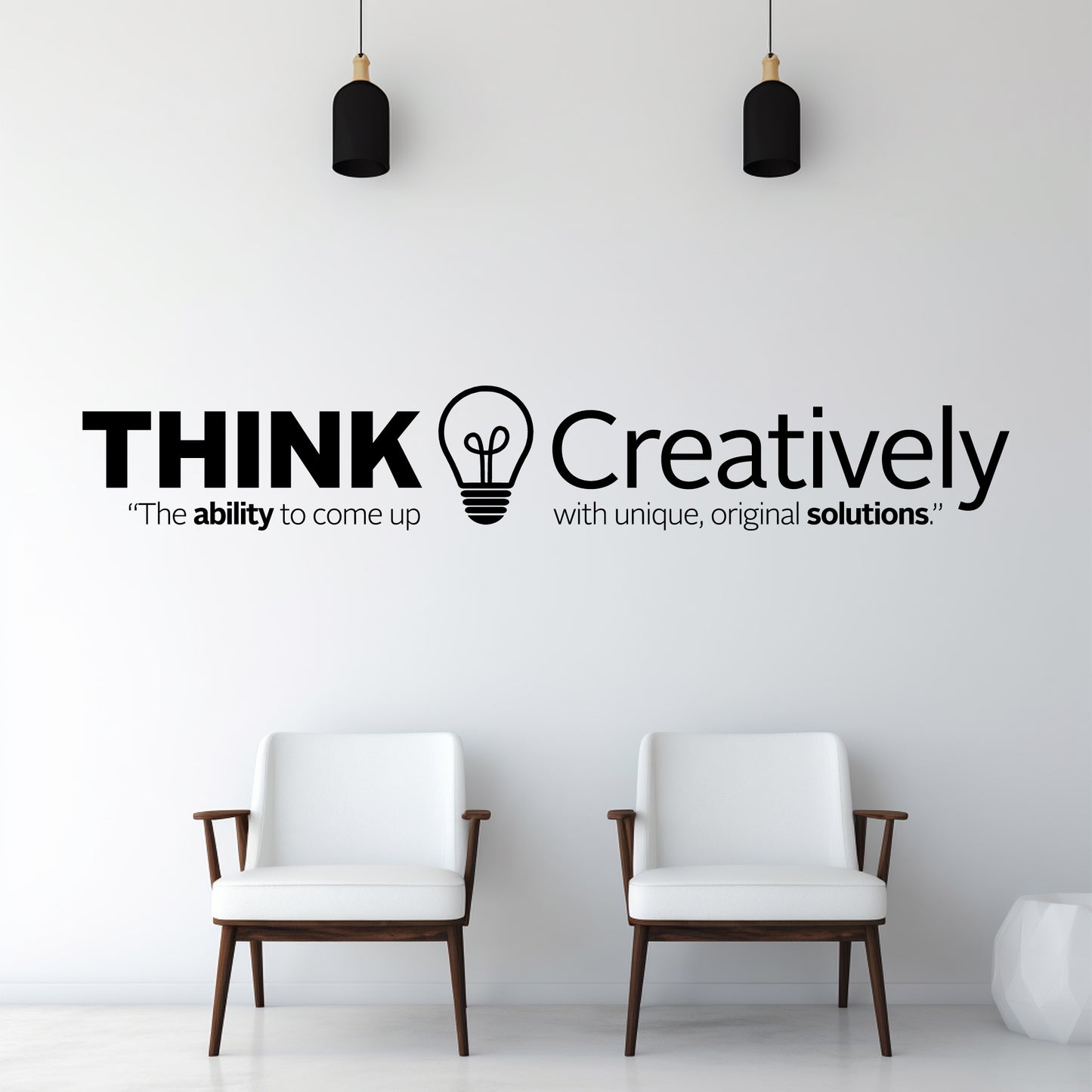 Two white chairs in a room with a wall quote 'THINK Creatively' and a light bulb symbol.