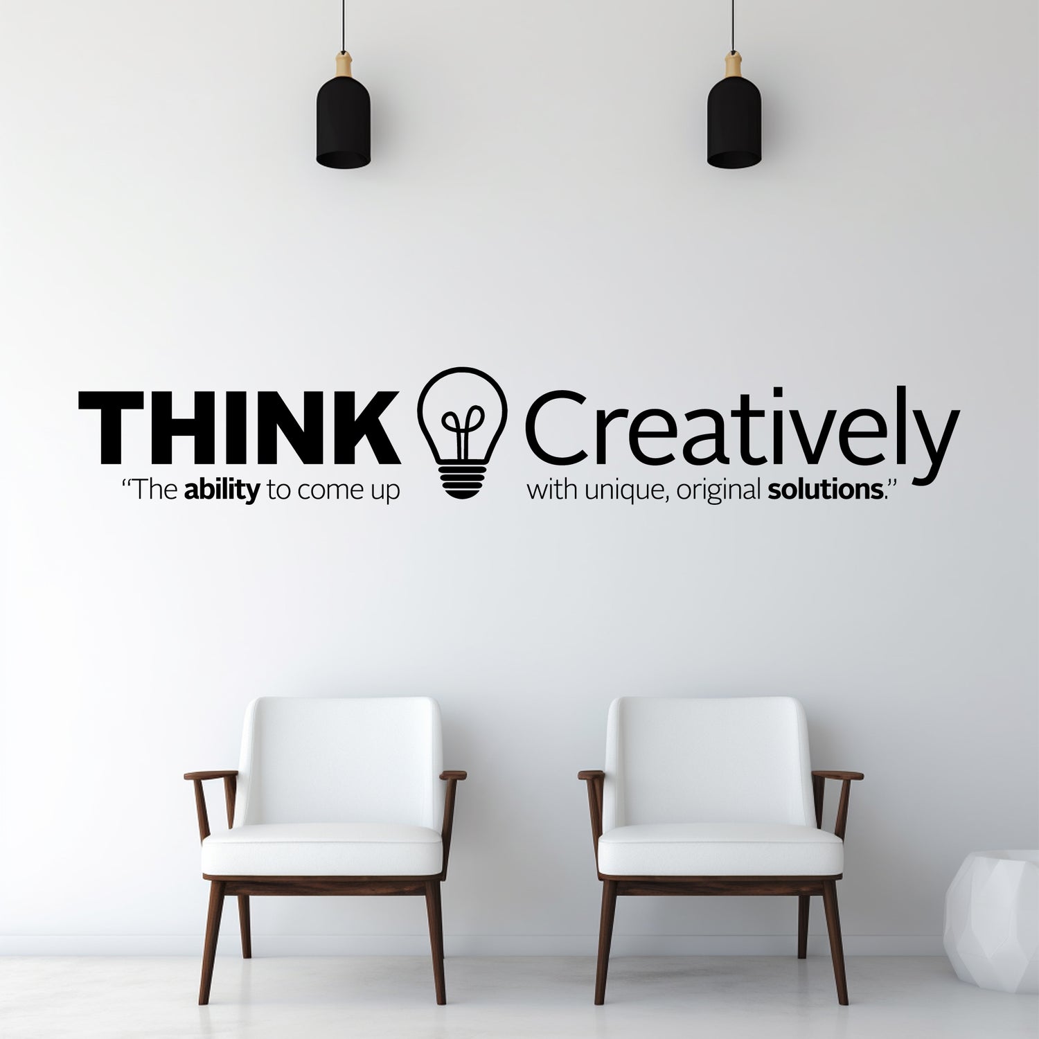 Two white chairs in a room with a wall quote 'THINK Creatively' and a light bulb symbol.