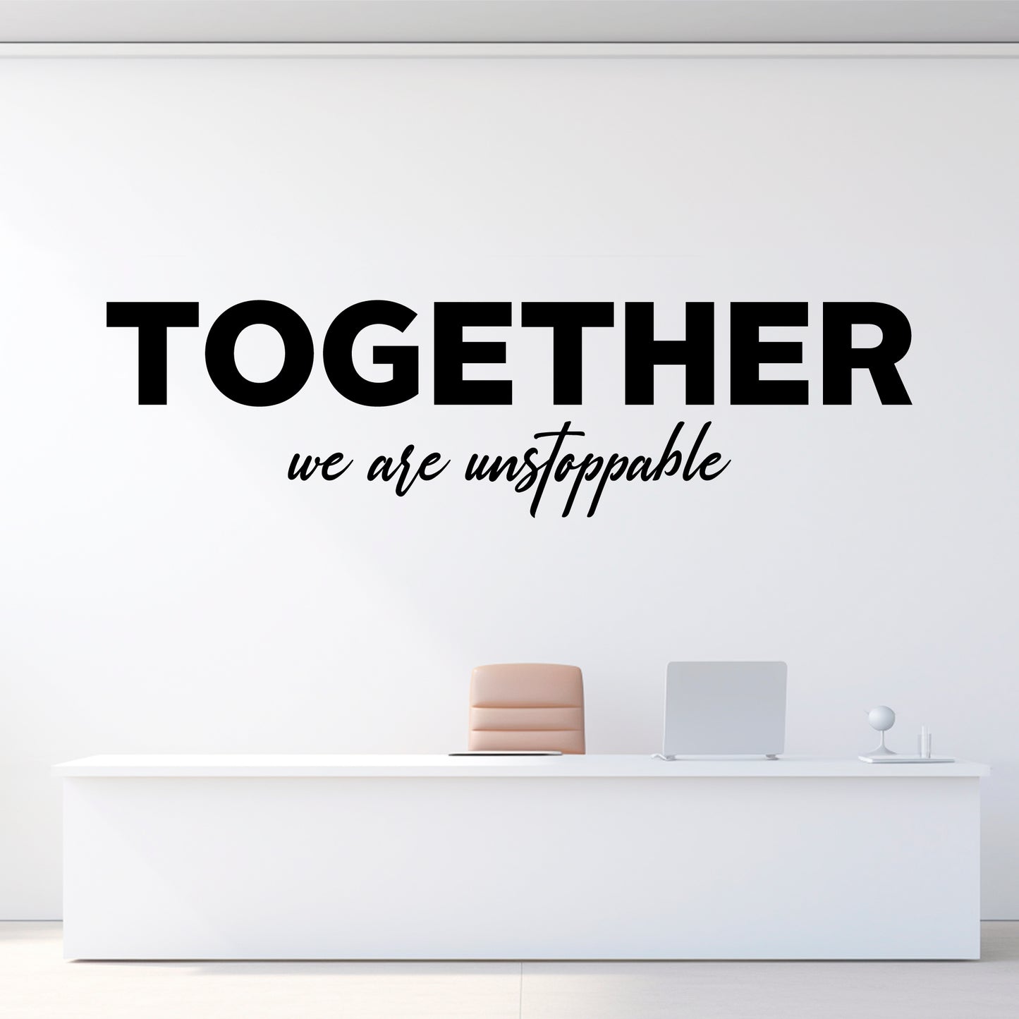 Wall decal with 'Together we are unstoppable' text on a white wall above a reception desk.