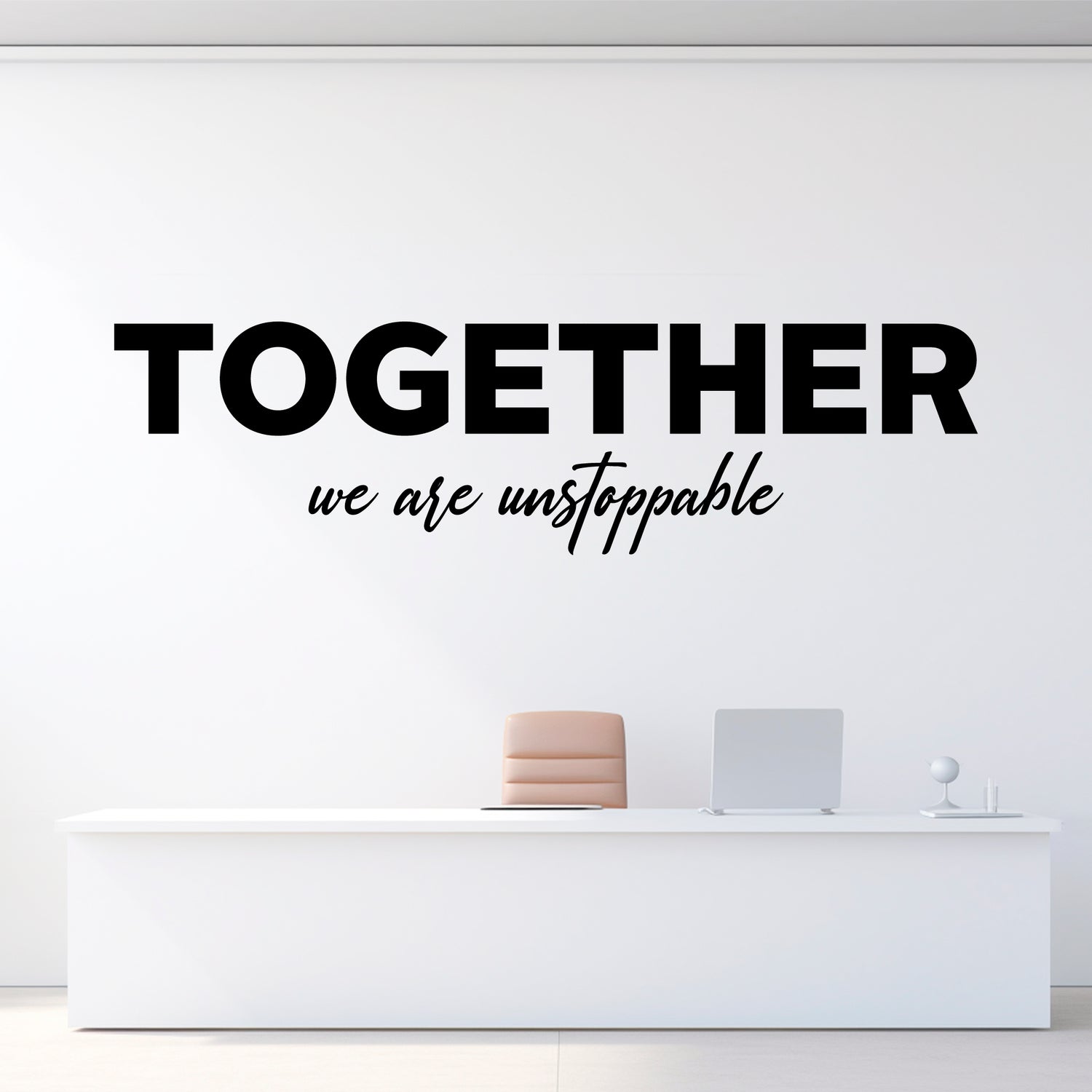 Wall decal with 'Together we are unstoppable' text on a white wall above a reception desk.