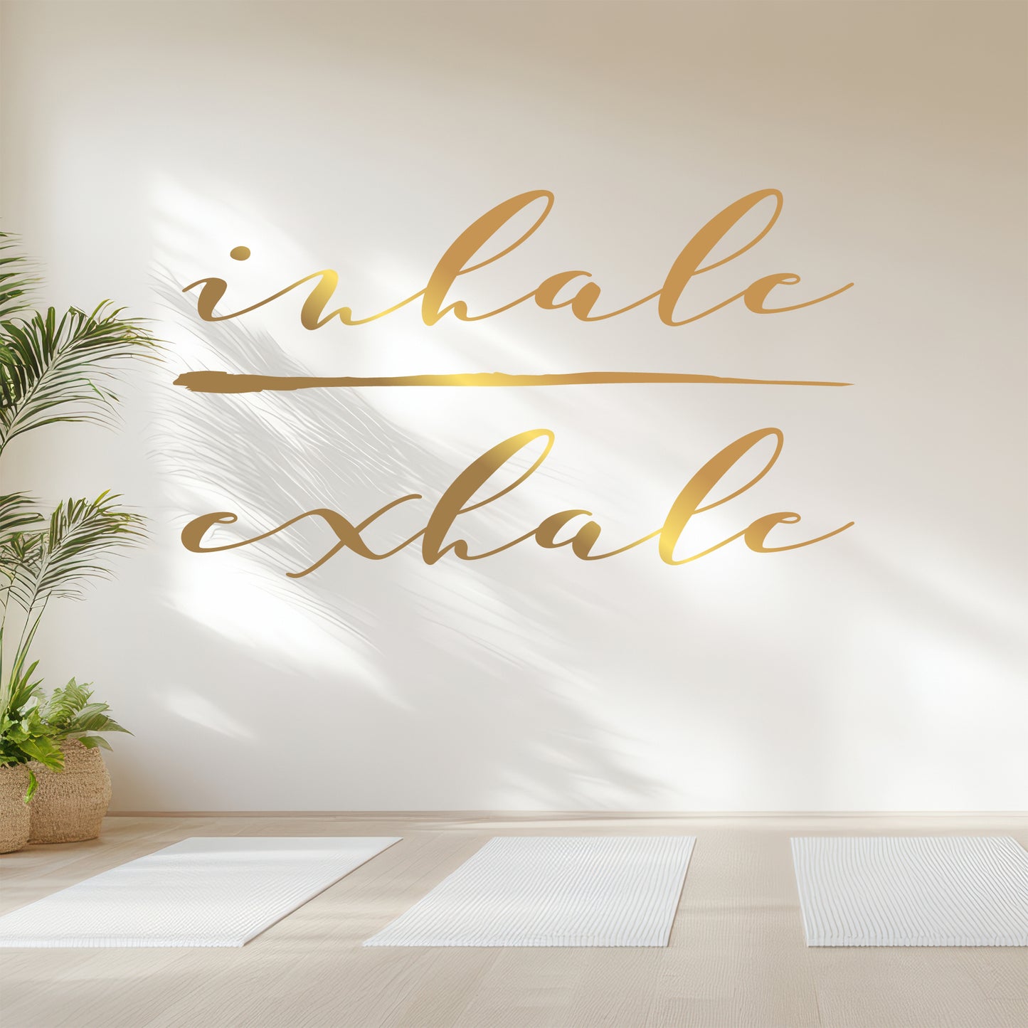 Yoga studio with 'inhale exhale' wall art and yoga mats on the floor.