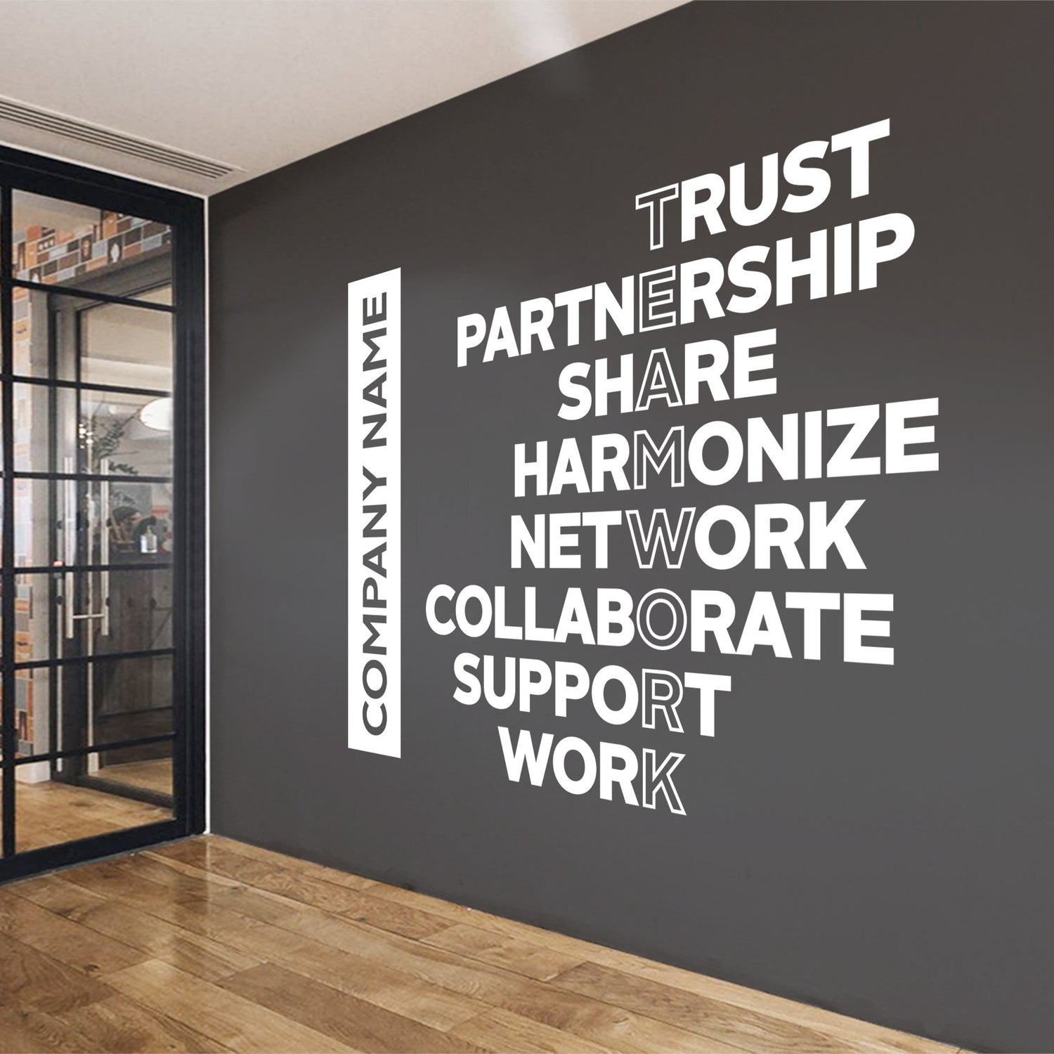 Wall with motivational phrases and a company name on a modern interior setting