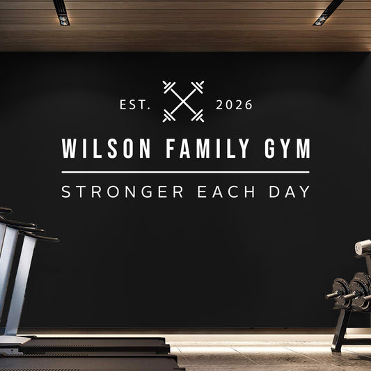 Gym interior with 'Wilson Family Gym' branding on a black wall.