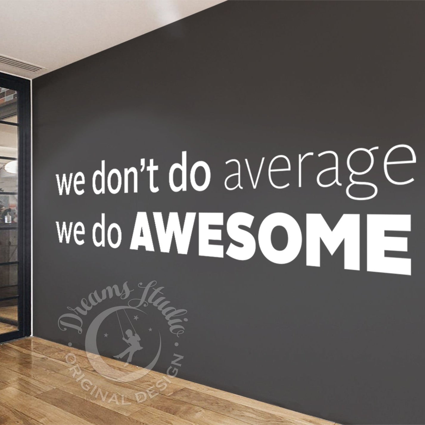Modern interior with a motivational quote on a wall, featuring glass doors and a dark wall.