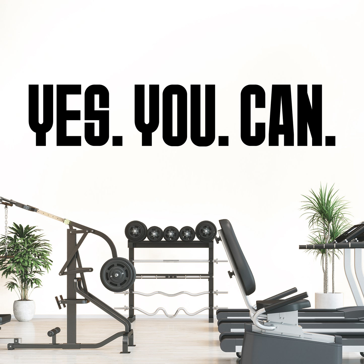 Gym equipment with 'YES. YOU. CAN.' text on a white wall