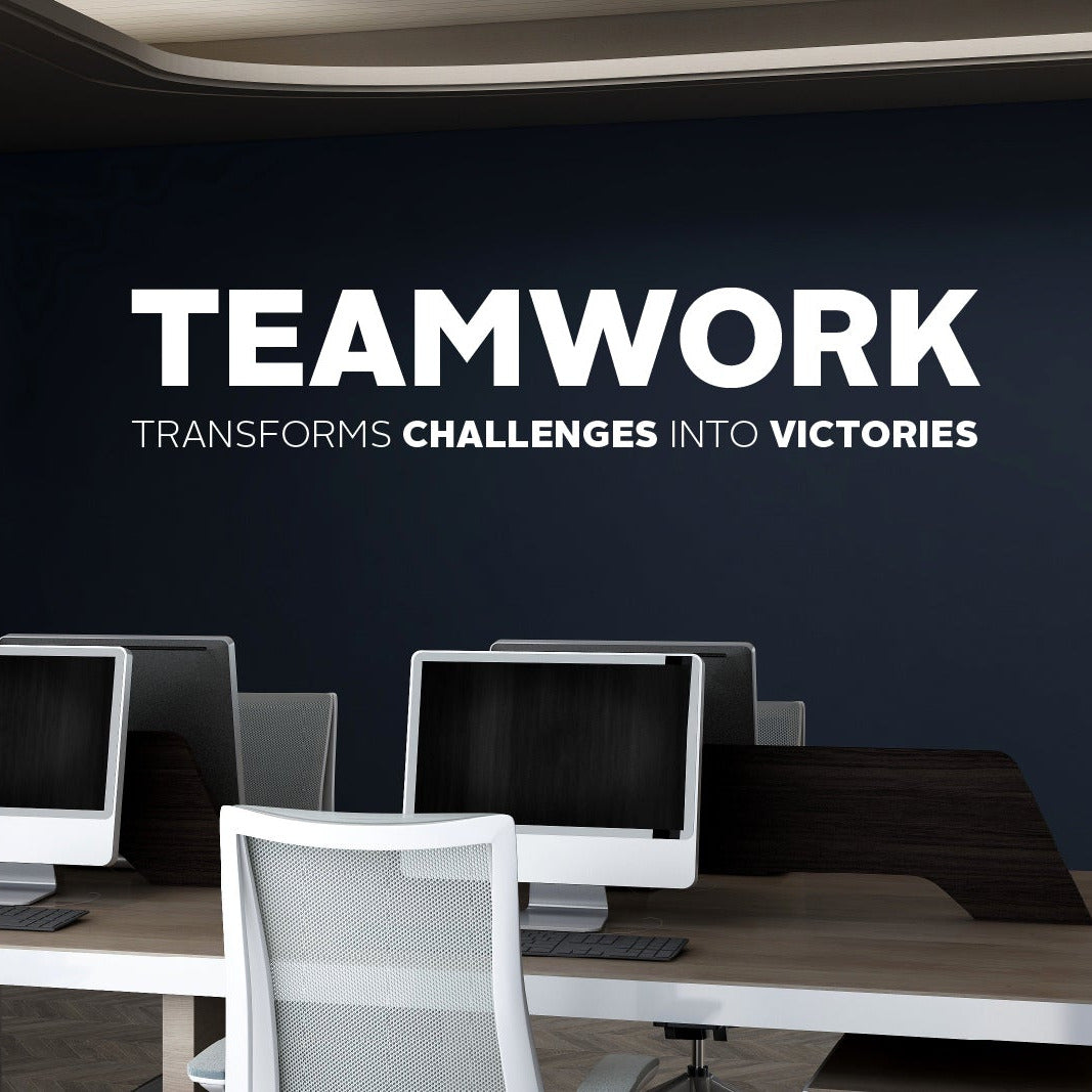 Modern office setup with computers and chairs, featuring a motivational quote on the wall.