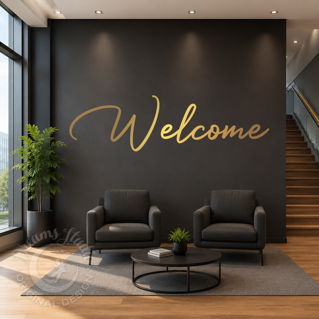 Modern interior with two dark gray armchairs, a small round table, and a 'Welcome' sign on a black wall.