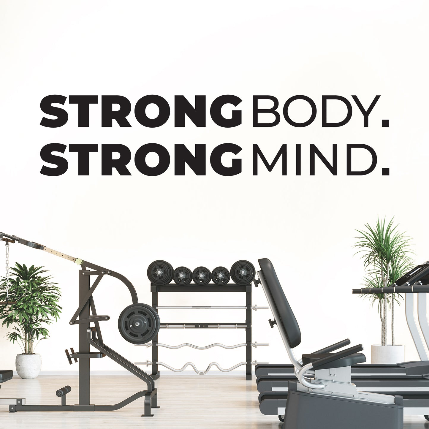 Gym equipment with 'Strong Body. Strong Mind.' text on a white wall.