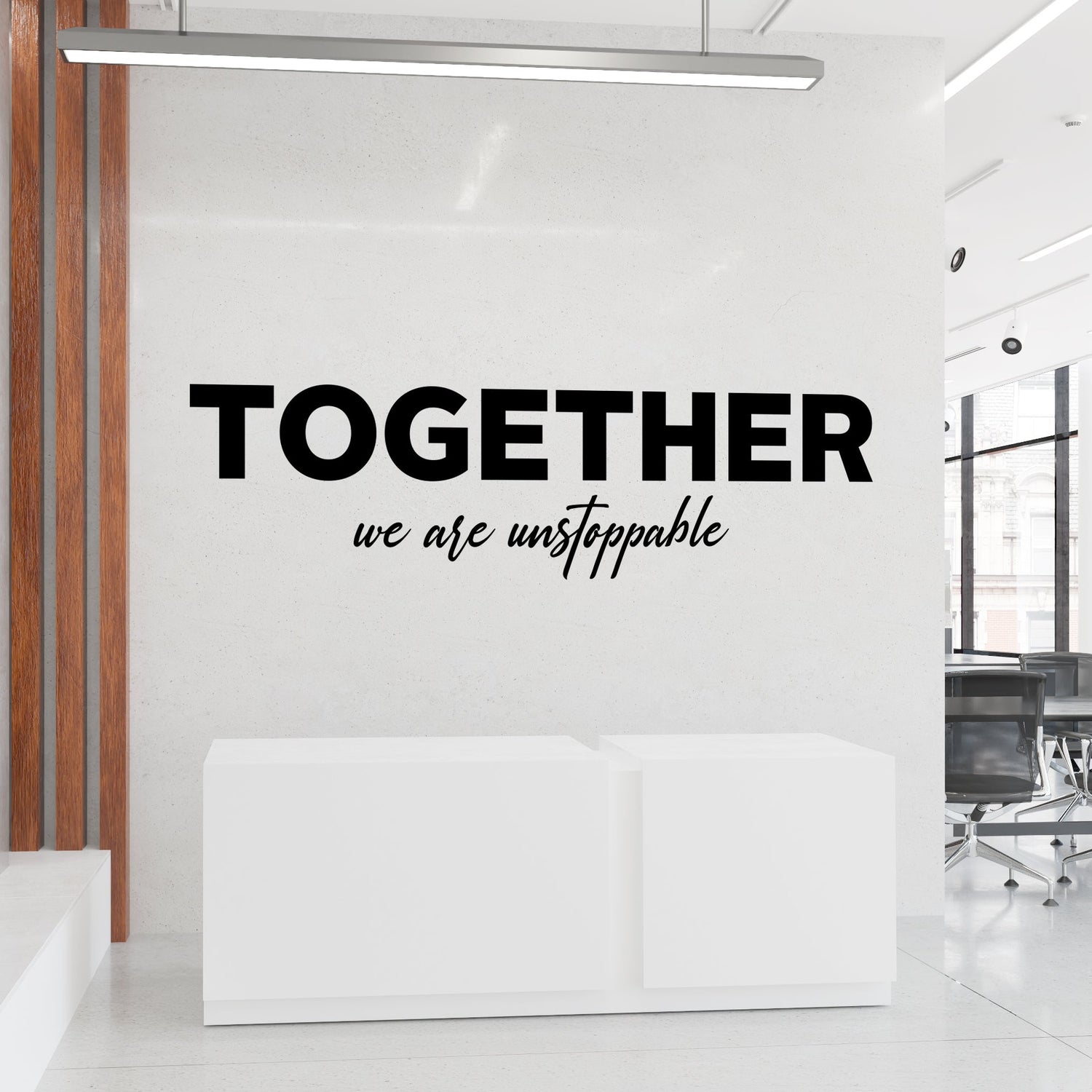 Modern office interior with motivational quote 'Together we are unstoppable' on a wall.