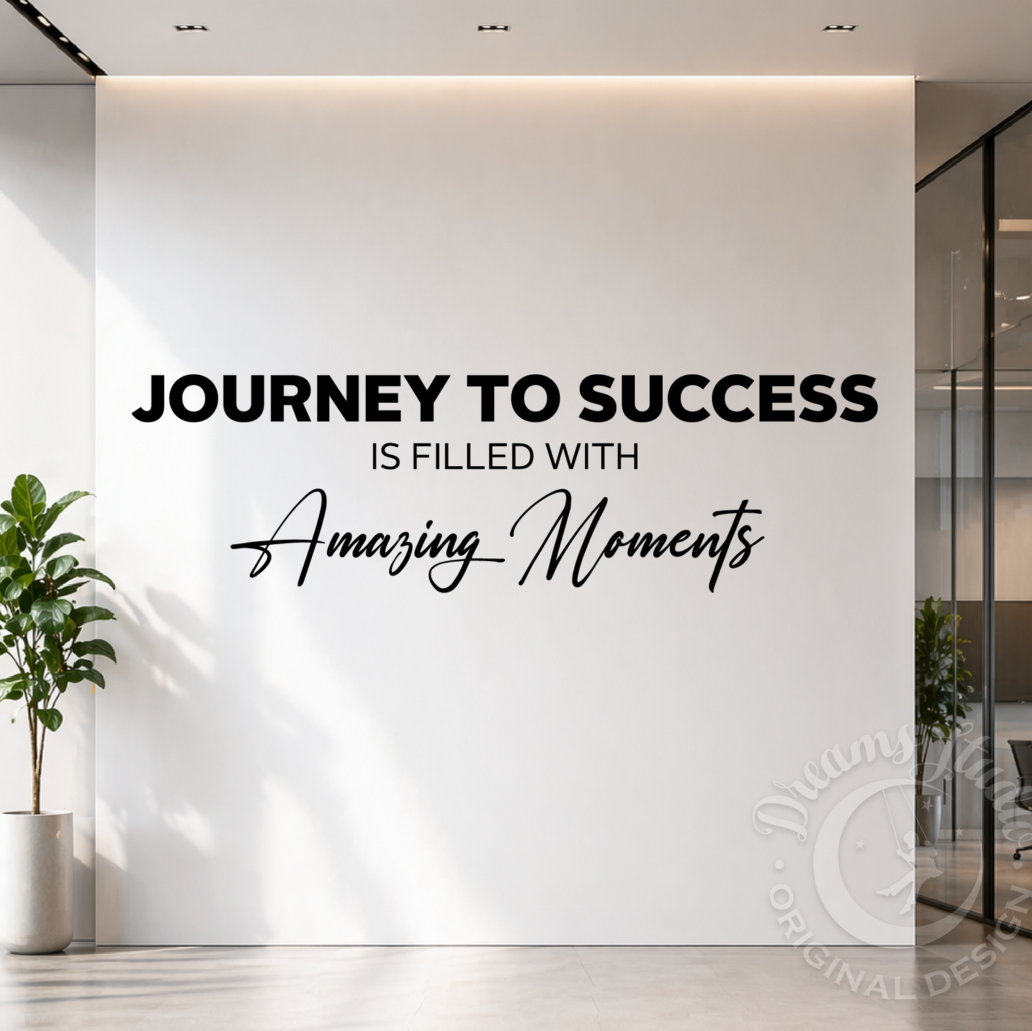 Black vinyl wall decal with the quote 'JOURNEY TO SUCCESS IS FILLED WITH Amazing Moments' displayed on a white office wall, flanked by a potted plant and glass partitions.