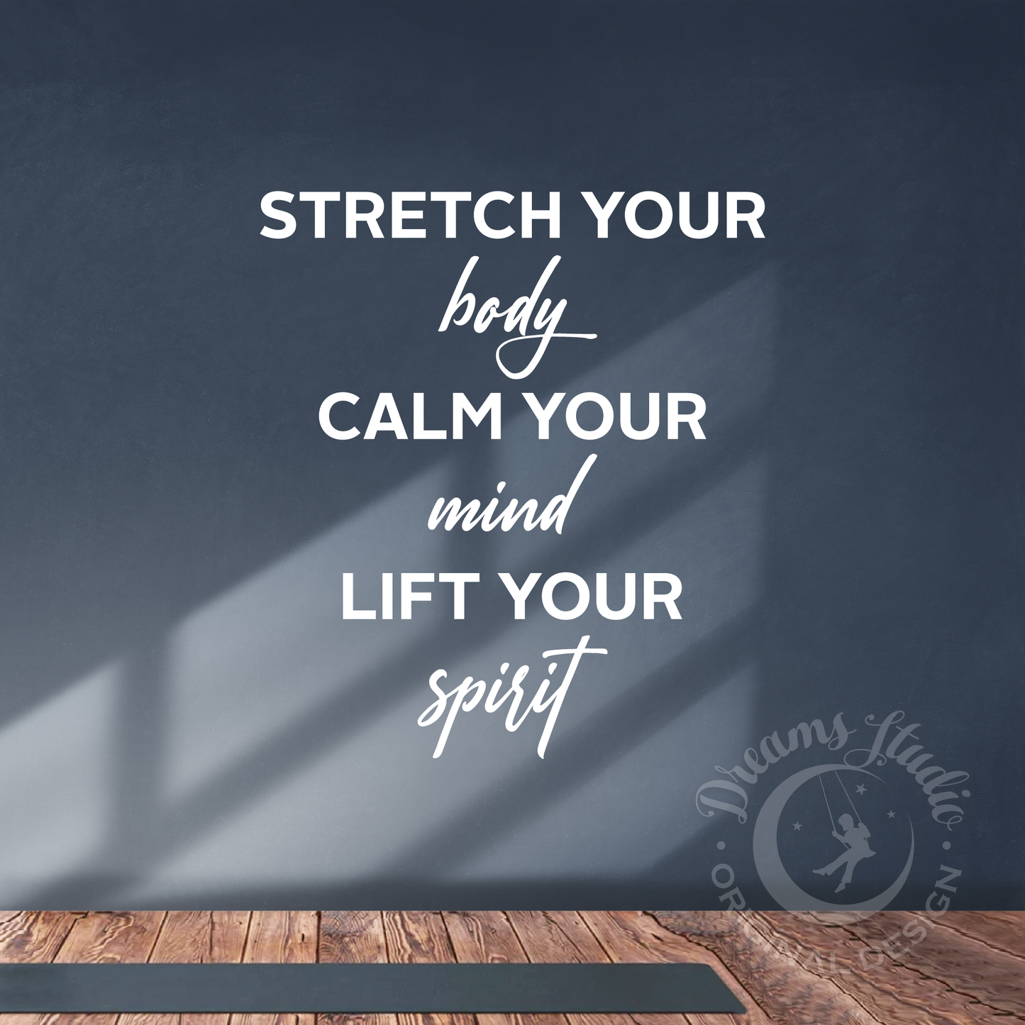 Motivational quote on a dark wall with a yoga mat on the floor, featuring the Dreams Studio logo.