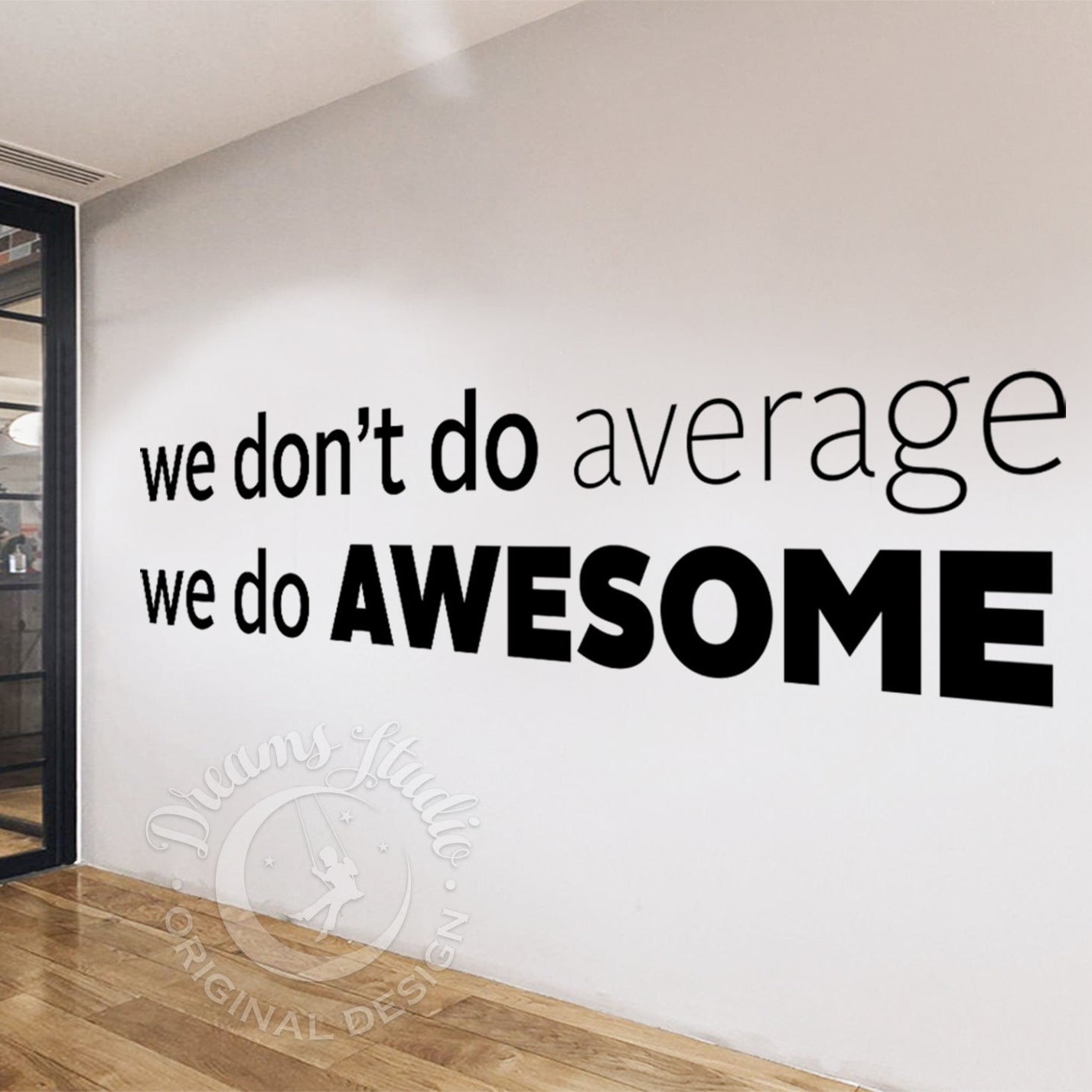 Wall with motivational quote 'we don't do average, we do AWESOME' in a modern interior setting.