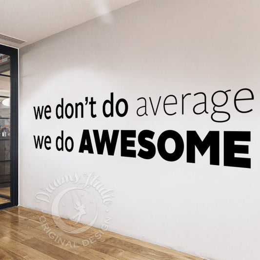Wall with motivational quote 'we don't do average, we do AWESOME' in a modern interior setting.