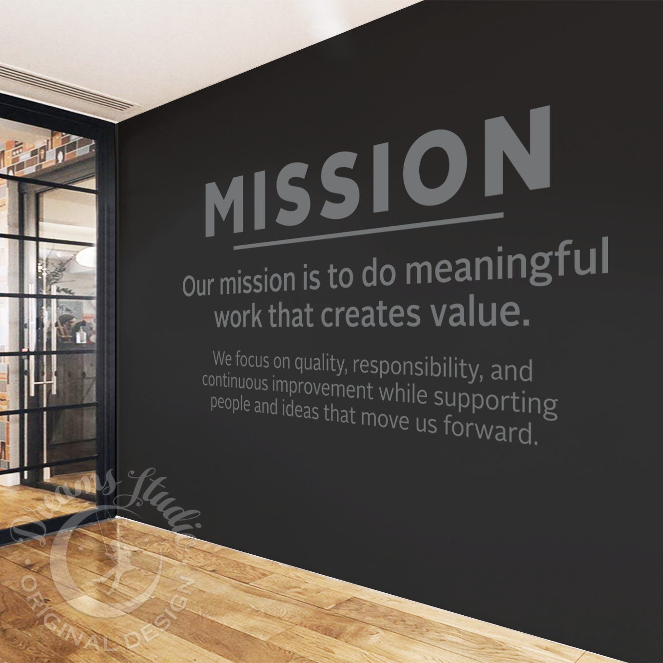 Modern office interior with a black wall displaying a mission statement.
