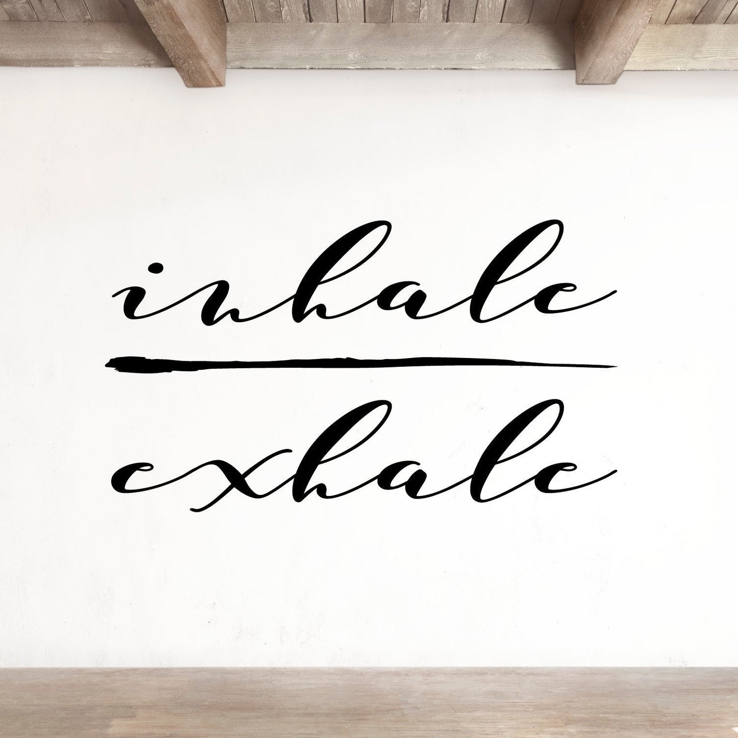 White wall with 'inhalе exhale' text in a minimalist room.