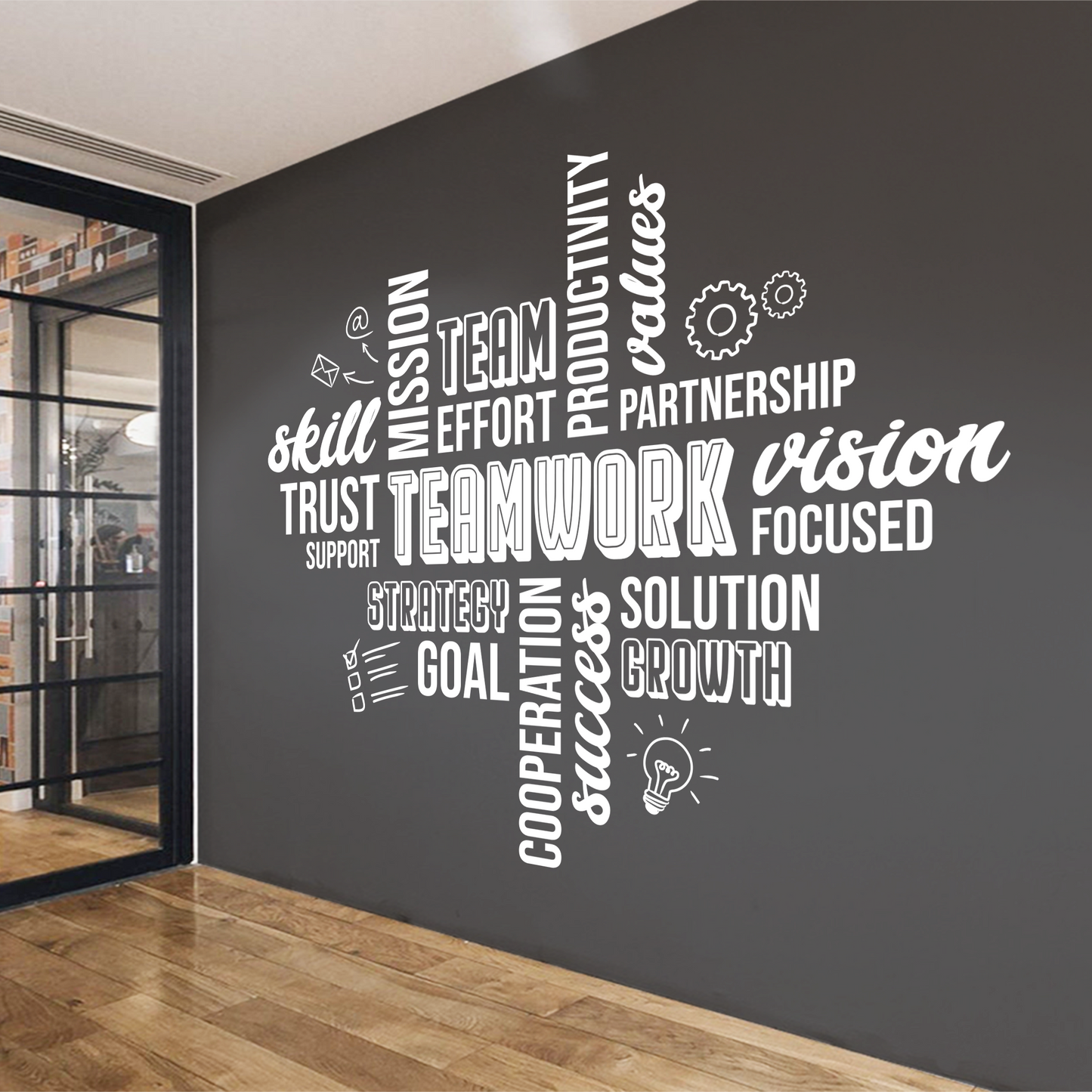 Motivational wall decal with words like 'teamwork', 'vision', 'success' on a dark wall.