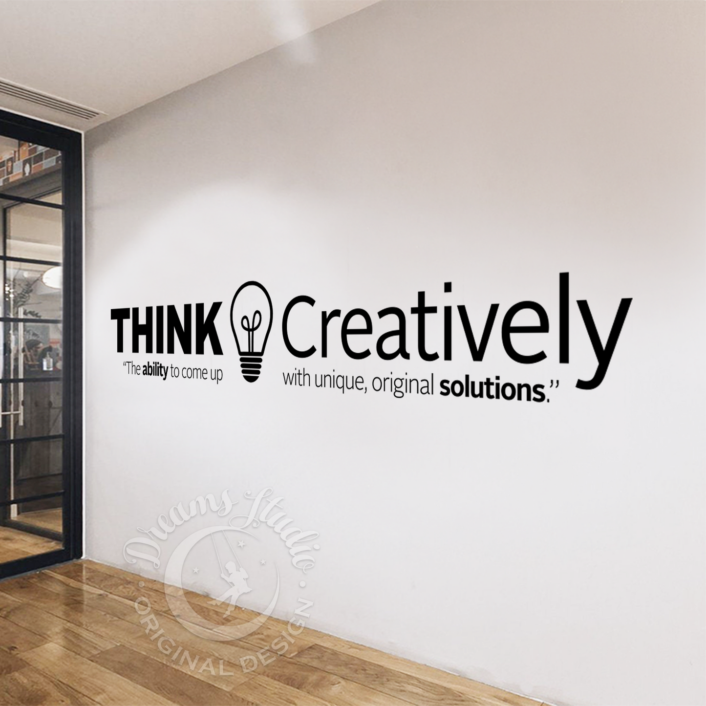 Modern office interior with a wall quote 'Think Creatively' and glass door.