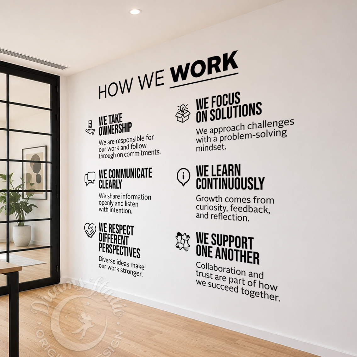 Wall with 'How We Work' wall decal in a modern office setting