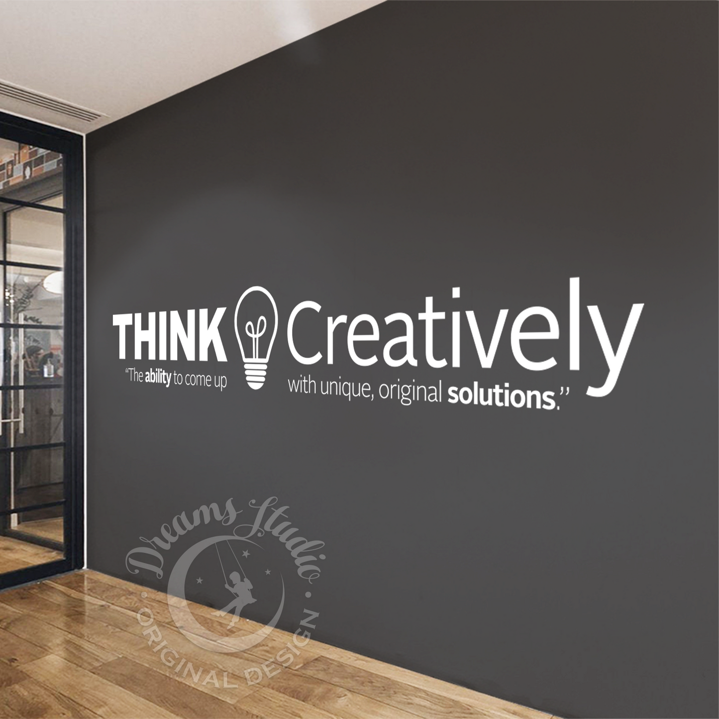 Modern interior with a wall featuring 'Think Creatively' quote and logo.
