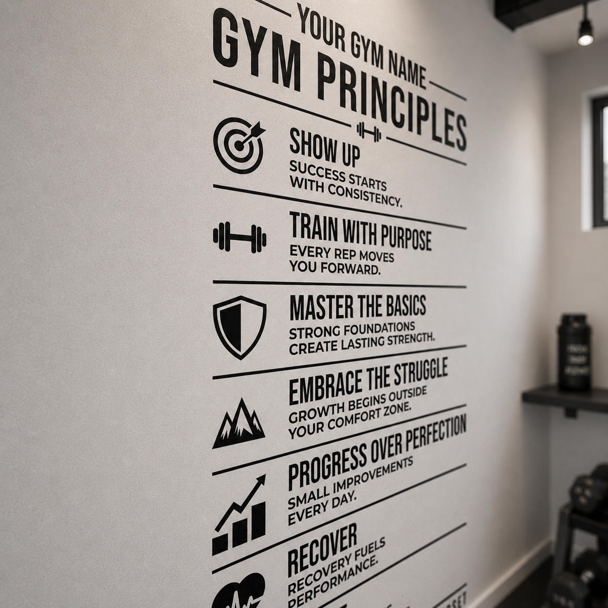 A black motivational gym wall poster with text and icons reading 'GYM PRINCIPLES' and fitness phrases, mounted on a white wall in an indoor gym space.