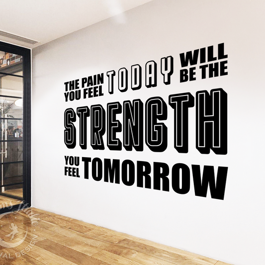 Motivational quote on a wall in a modern interior setting with glass doors.